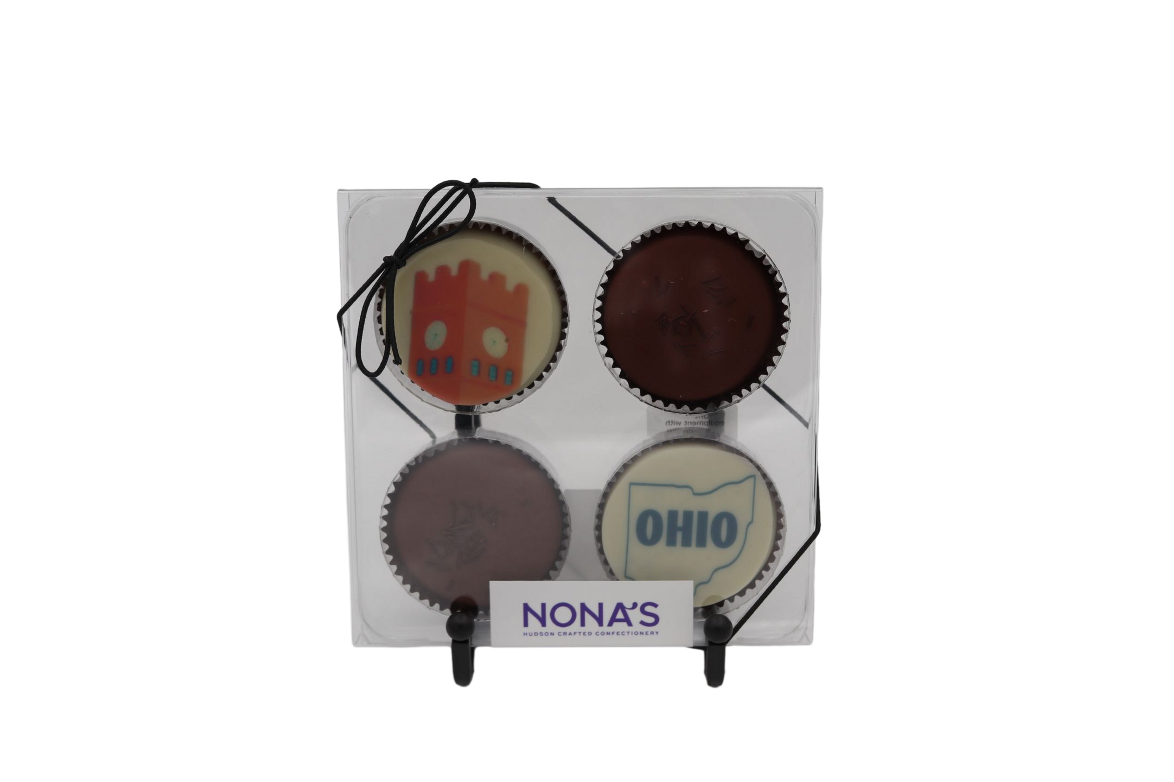 Set of four choclate dipped cookies with different designs representing hudson ohio on a white background, branded 'Nona's'.